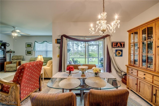 dining room featuring a wealth of natural light, light tile patterned floors, and ceiling fan with notable chandelier