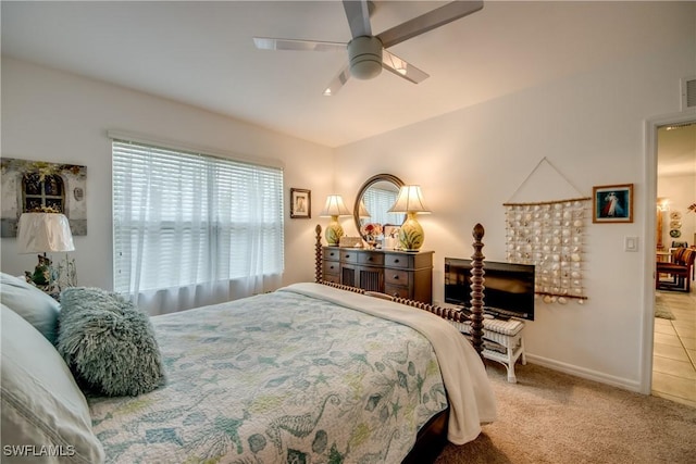 carpeted bedroom featuring a fireplace and ceiling fan