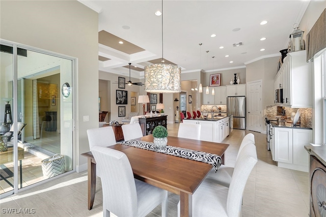 tiled dining room featuring beamed ceiling, ornamental molding, coffered ceiling, and sink