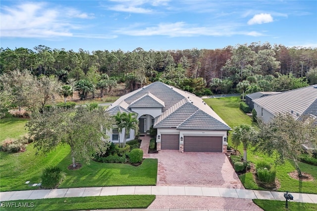 view of front of home featuring a garage and a front lawn