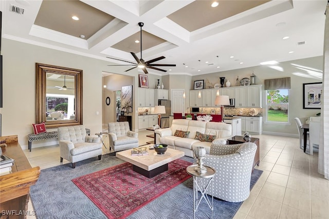 living room featuring a healthy amount of sunlight, coffered ceiling, and ornamental molding