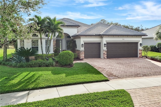 view of front of property featuring a garage and a front yard