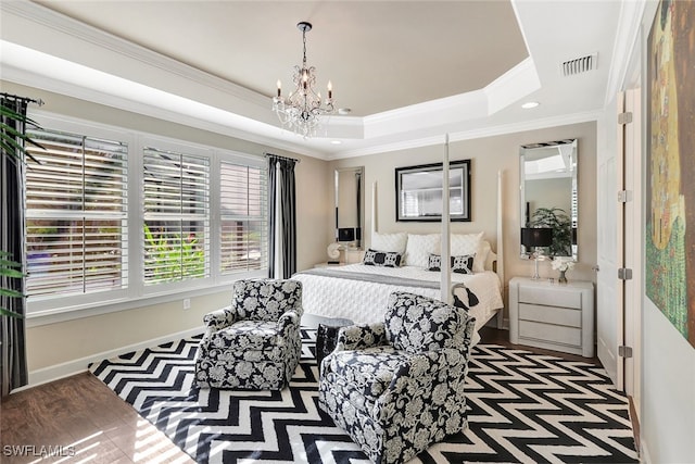 bedroom featuring a tray ceiling, an inviting chandelier, and ornamental molding