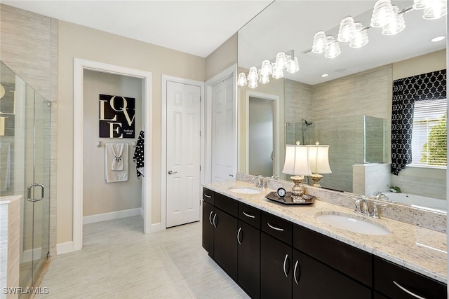 bathroom with tile patterned flooring, vanity, and shower with separate bathtub