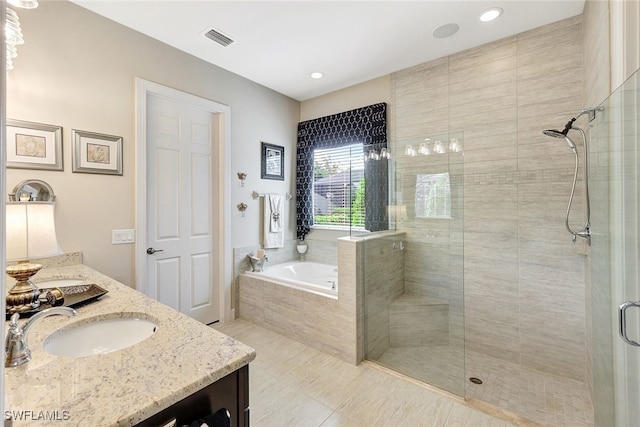 bathroom featuring tile patterned flooring, vanity, and separate shower and tub