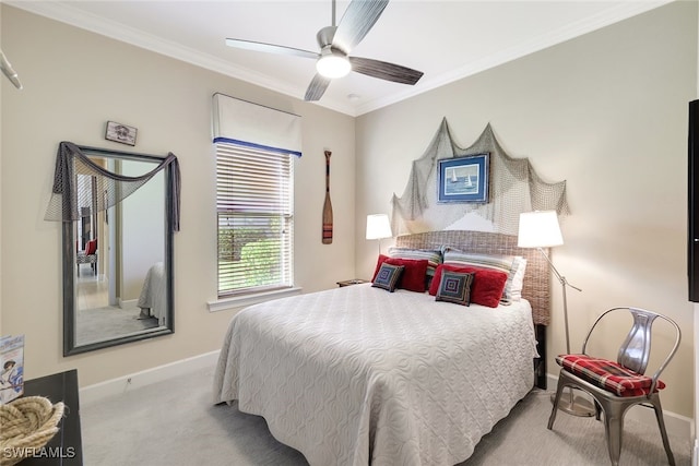 carpeted bedroom with ceiling fan and ornamental molding