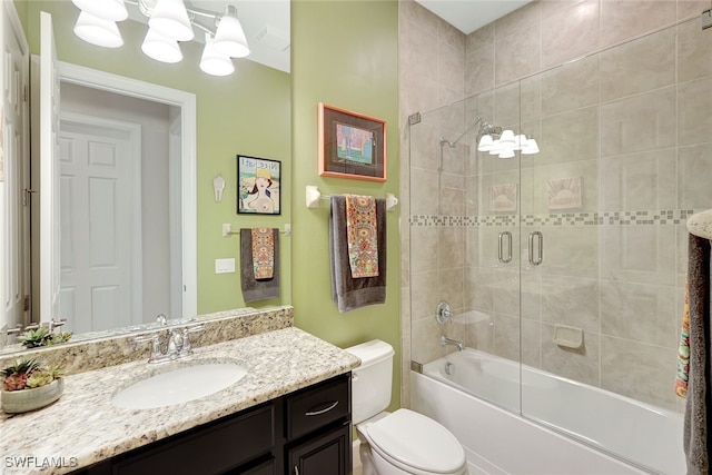 full bathroom featuring enclosed tub / shower combo, vanity, a chandelier, and toilet