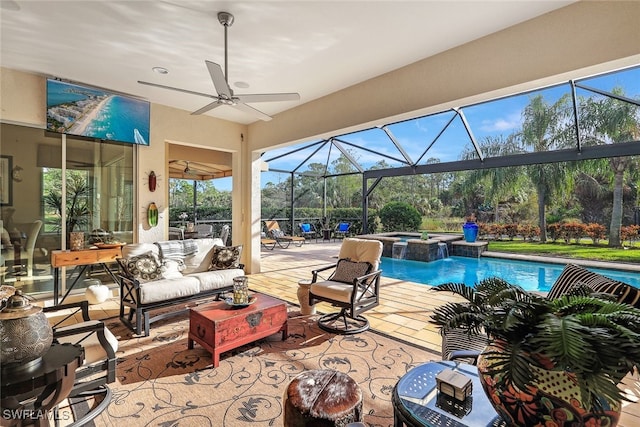 view of pool with an outdoor hangout area, ceiling fan, a lanai, an in ground hot tub, and a patio area