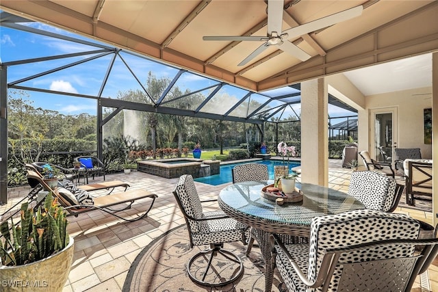 view of patio with ceiling fan, a pool with hot tub, and glass enclosure