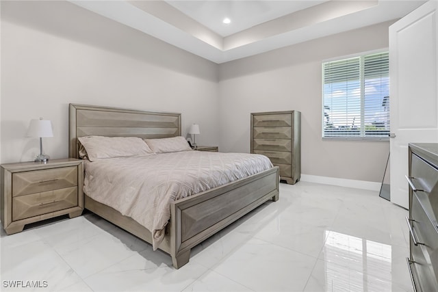 bedroom featuring recessed lighting, baseboards, a raised ceiling, and marble finish floor