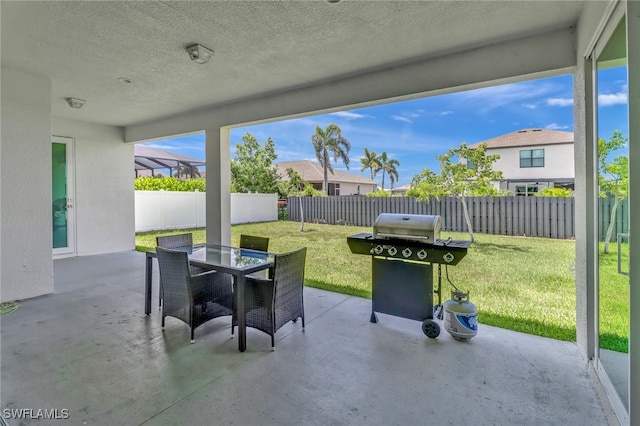 view of patio featuring outdoor dining area, area for grilling, and a fenced backyard