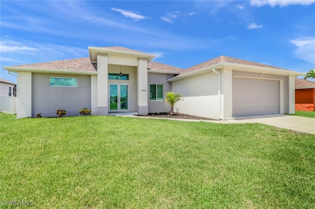 prairie-style house with driveway, stucco siding, a front lawn, french doors, and a garage