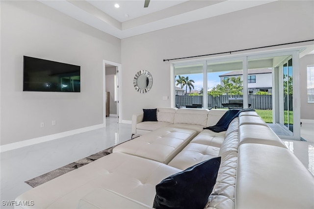 living area with recessed lighting, a healthy amount of sunlight, and baseboards