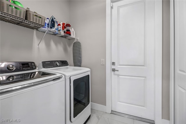 clothes washing area featuring washer and clothes dryer