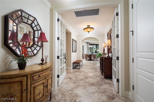 corridor featuring crown molding and french doors