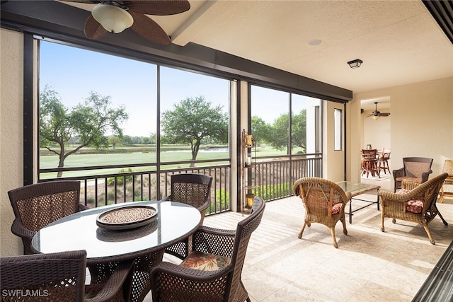 sunroom / solarium with plenty of natural light and ceiling fan