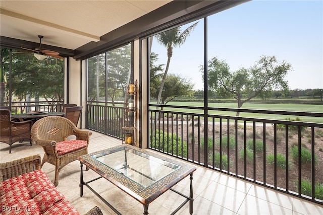 sunroom with beam ceiling and ceiling fan