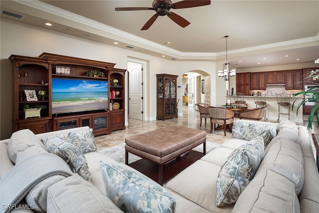 living room featuring ceiling fan with notable chandelier and crown molding