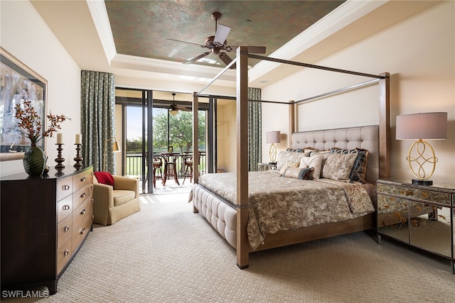 bedroom with a tray ceiling, access to exterior, ceiling fan, and light carpet