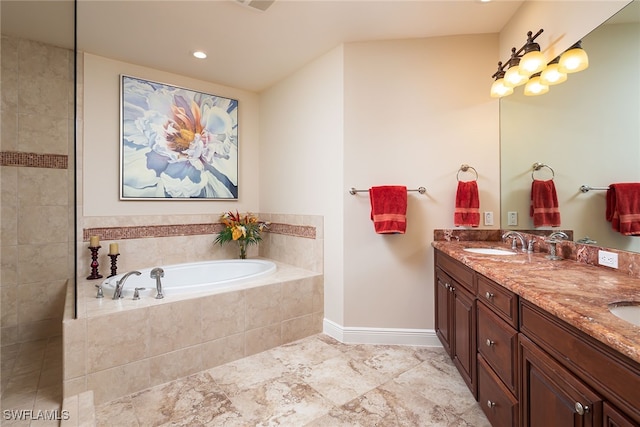 bathroom with vanity and a relaxing tiled tub