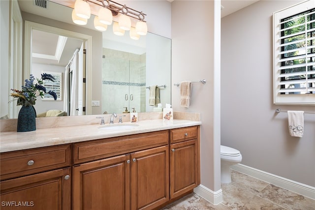 bathroom featuring vanity, toilet, and an enclosed shower