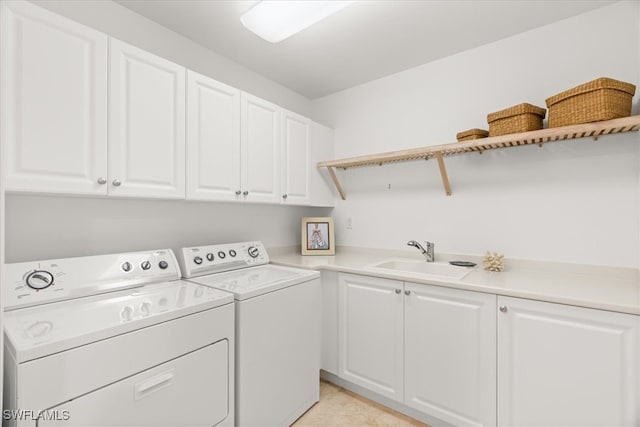 laundry room with separate washer and dryer, sink, and cabinets