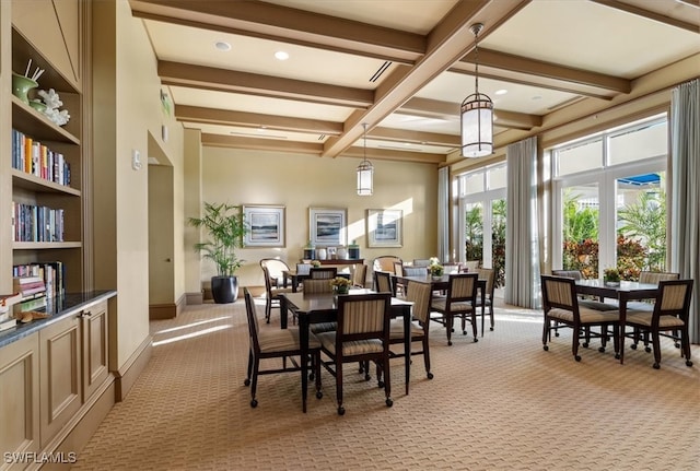 carpeted dining room featuring beamed ceiling