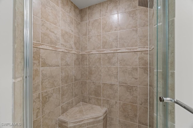 bathroom featuring a shower with shower door