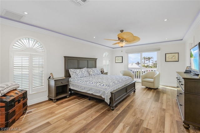 bedroom featuring ceiling fan, light hardwood / wood-style floors, ornamental molding, and multiple windows