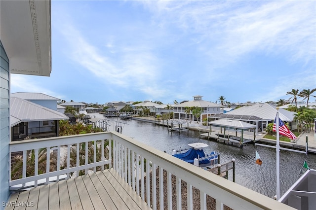 wooden deck featuring a water view and a boat dock