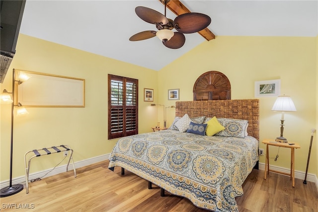 bedroom featuring vaulted ceiling with beams, hardwood / wood-style flooring, and ceiling fan