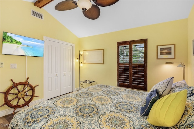 bedroom featuring hardwood / wood-style floors, ceiling fan, a closet, and lofted ceiling with beams