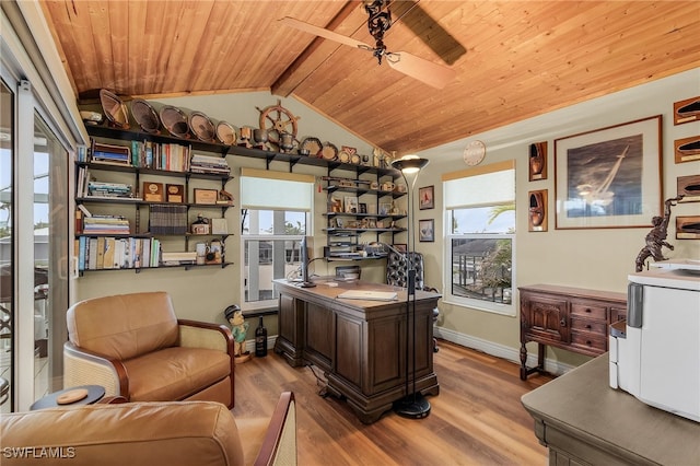 office space with plenty of natural light, lofted ceiling with beams, and light wood-type flooring