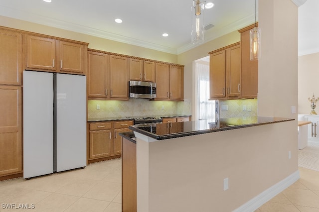 kitchen with light tile patterned floors, kitchen peninsula, crown molding, and appliances with stainless steel finishes