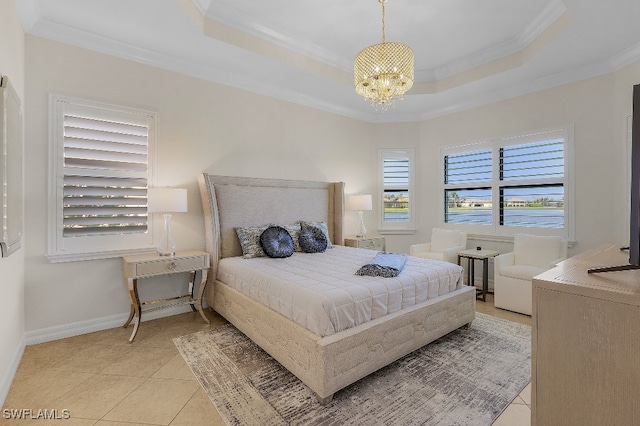 bedroom with a chandelier, light tile patterned floors, a tray ceiling, and crown molding