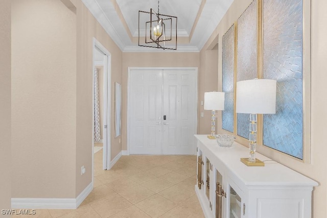 3741 Pleasant Springs Dr, Naples, FL 34119 - foyer entrance featuring crown molding, a tray ceiling, a chandelier, light tile patterned flooring, and baseboards