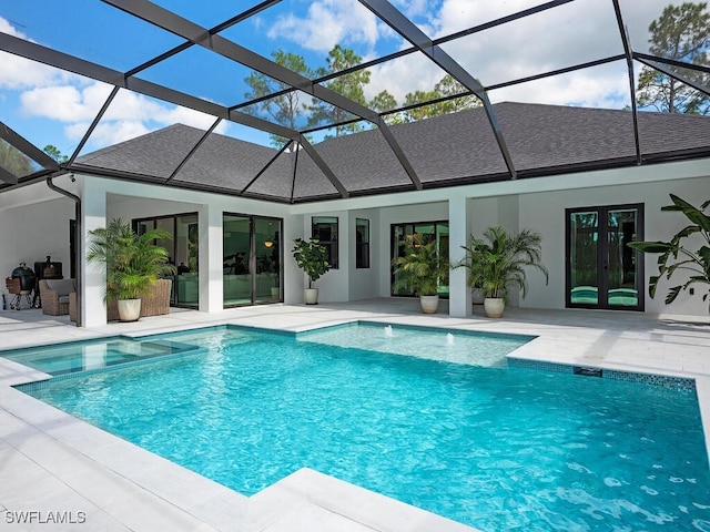 view of pool with a lanai, a patio area, and french doors