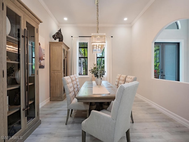 dining area featuring ornamental molding and light wood-type flooring