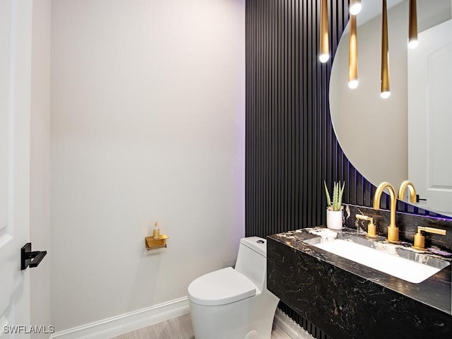 bathroom featuring hardwood / wood-style floors, toilet, and sink