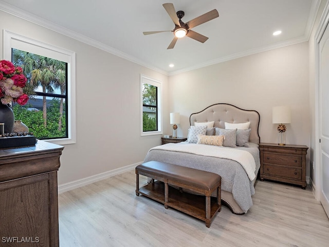 bedroom with light hardwood / wood-style floors, ceiling fan, and crown molding