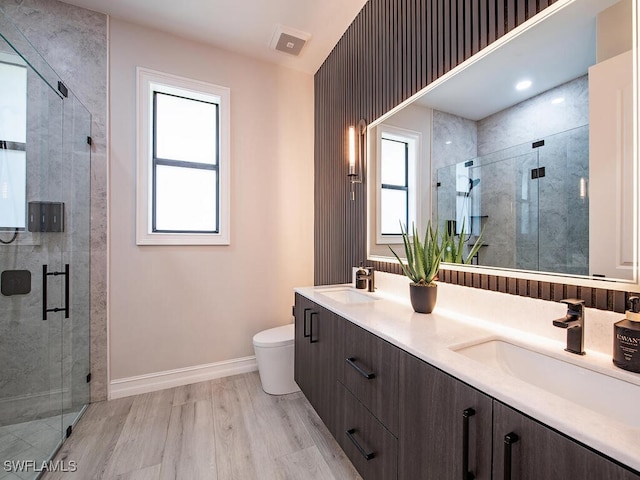 bathroom featuring hardwood / wood-style floors, vanity, toilet, and plenty of natural light