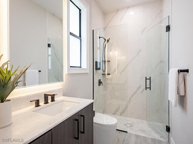 bathroom featuring hardwood / wood-style flooring, plenty of natural light, an enclosed shower, and vanity