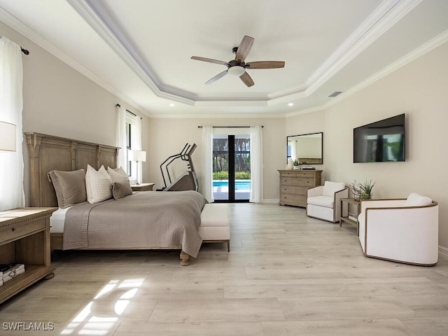 bedroom with access to exterior, a raised ceiling, light hardwood / wood-style flooring, and ceiling fan