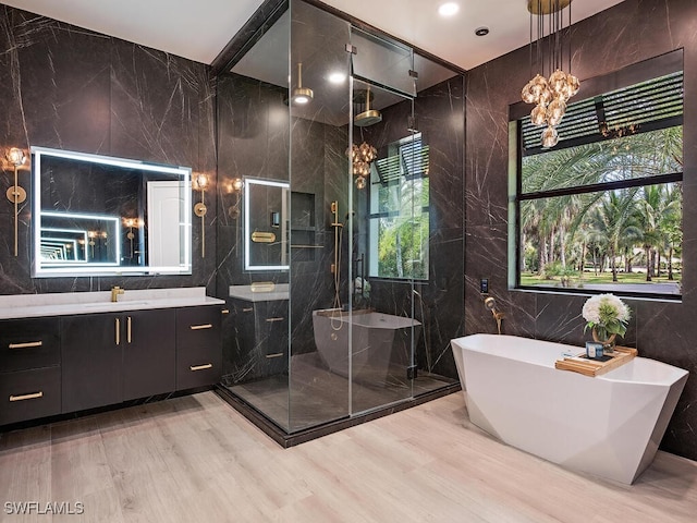 bathroom with vanity, plus walk in shower, wood-type flooring, and tile walls