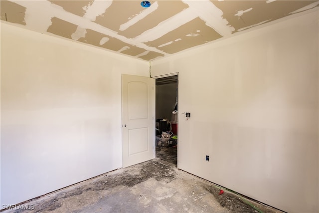 unfurnished room featuring concrete floors