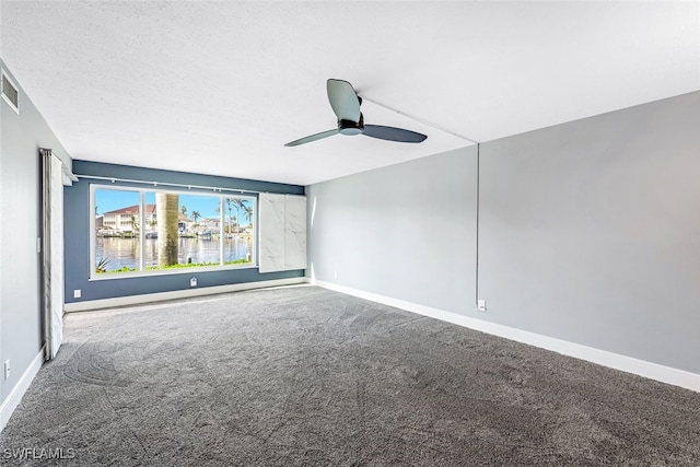 carpeted spare room with baseboards, a textured ceiling, and a ceiling fan