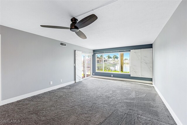 empty room featuring carpet flooring, baseboards, and visible vents