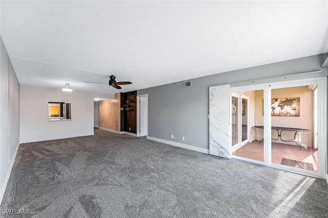 unfurnished living room featuring visible vents, baseboards, a ceiling fan, and carpet flooring