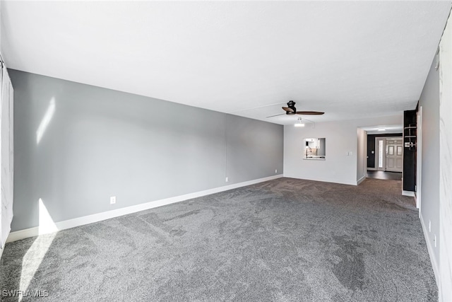 unfurnished living room featuring baseboards, ceiling fan, and dark colored carpet