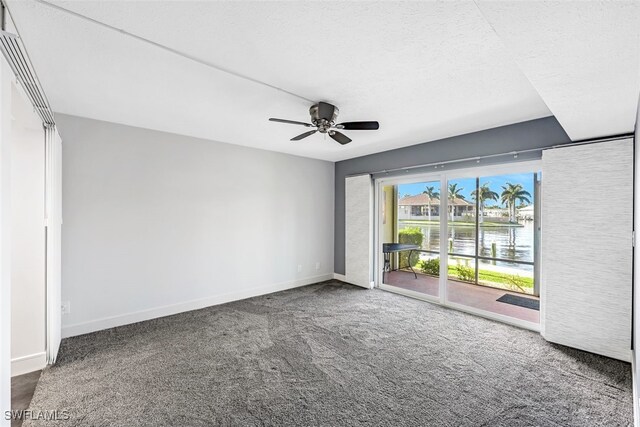 empty room with a ceiling fan, carpet, baseboards, and a textured ceiling